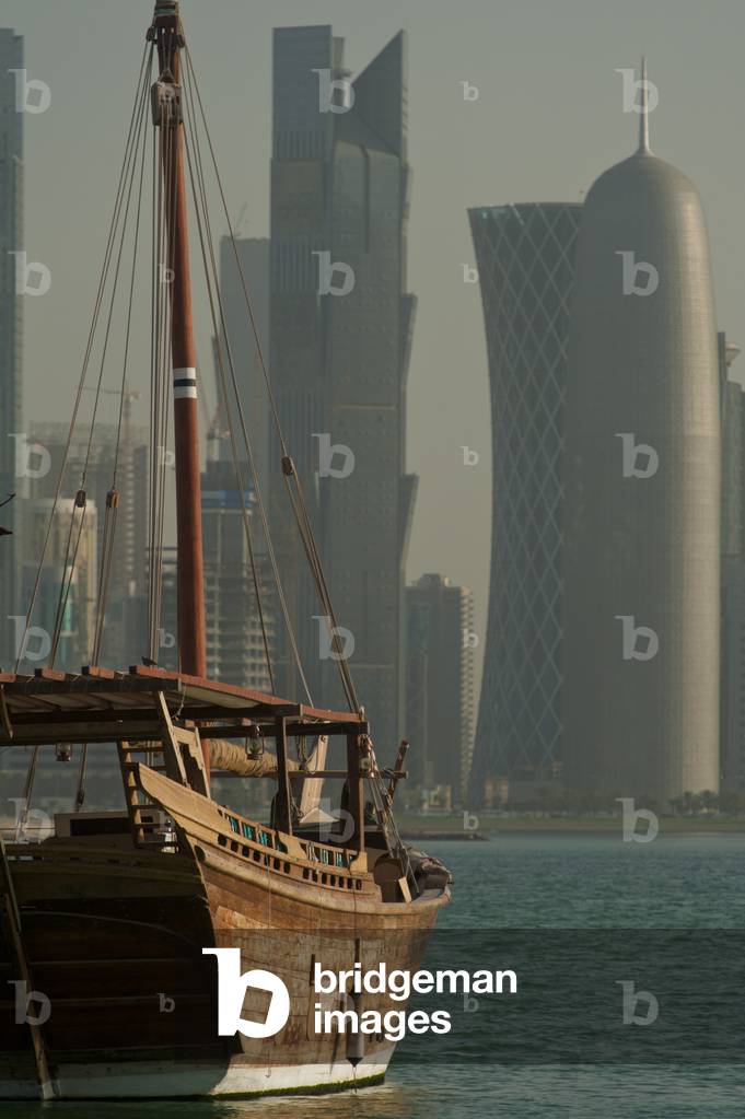 Wooden boats in the harbour with the modern skyline of Doha behind, Doha, Qatar (photo)