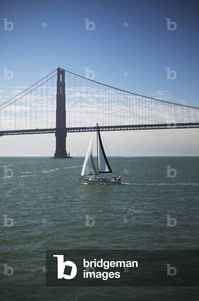 The Golden Gate Bridge is seen behind a sailboat in San Francisco Bay, San Francisco, California, USA (photo)