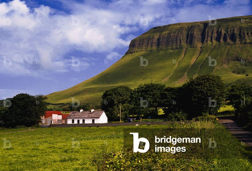 Ben Bulben, Co Sligo, Ireland, Cottage Below A Large Rock Formation (photo)
