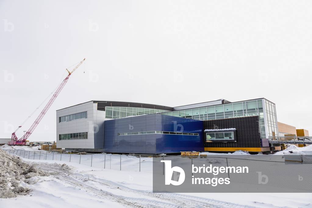 A crane towers over an unfinished hospital, Barrow, North Slope, Arctic Alaska, USA, Winter (photo)