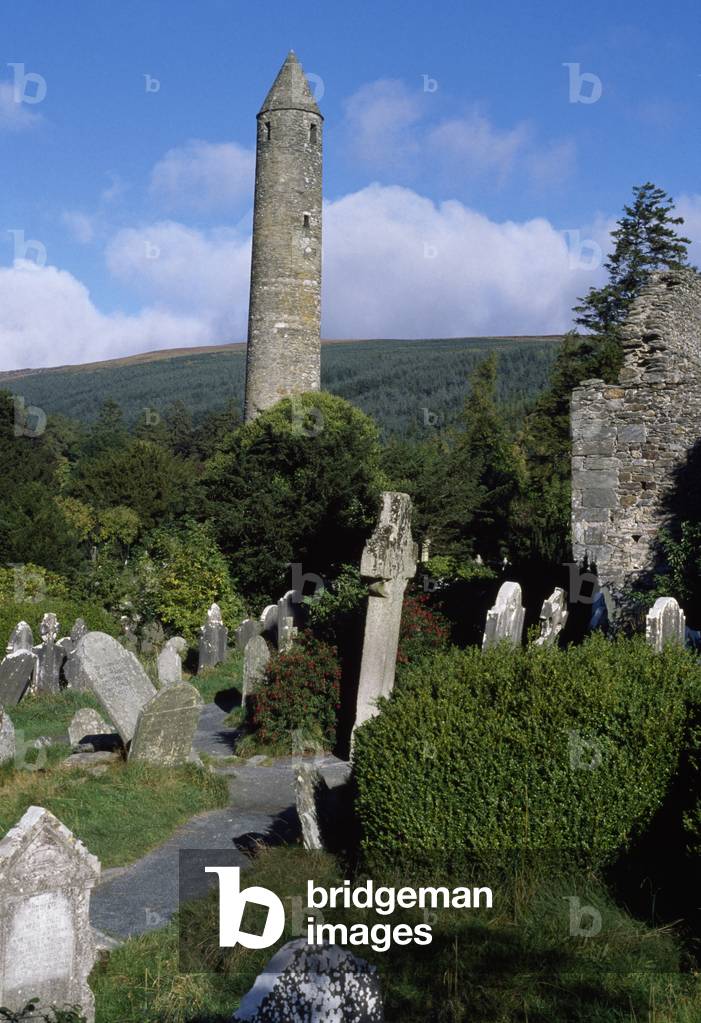 Glendalough, Co Wicklow, Ireland; Gravestones And Round Tower On A 6Th Century Monastic Site (photo)