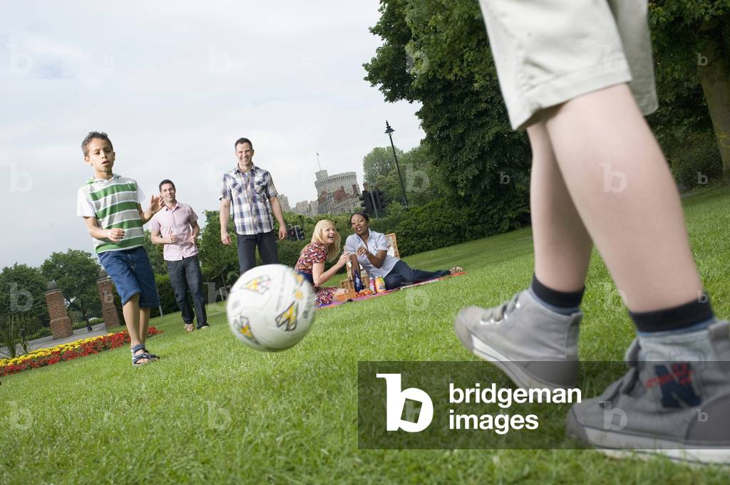 Young Families Picnicking and Playing in Park, UK (photo)