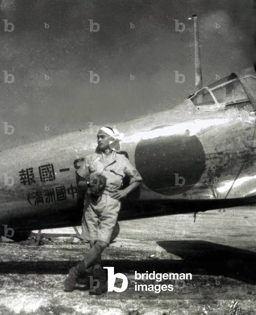 World War II,Japanese pilot poses by Zero fighter in the South Pacific