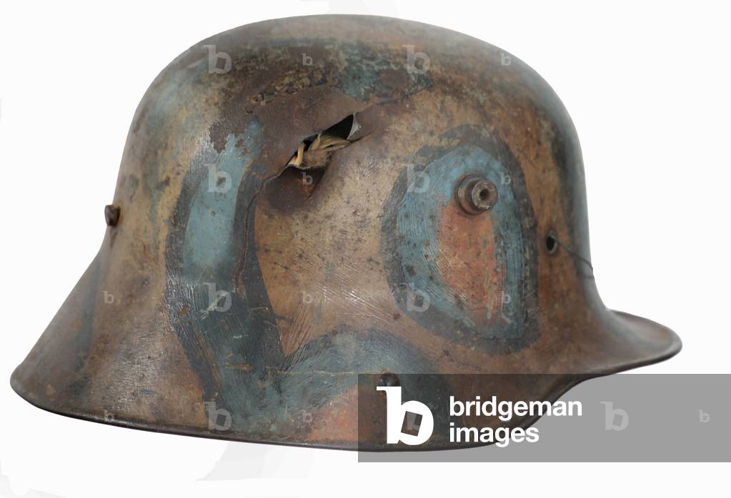 German M1916 Camouflage painted helmet with a bullet hole