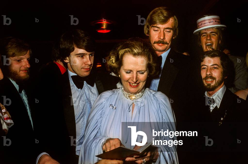 Margaret Thatcher accompanied by protection detectives signing autographs at the Conservative Party Conference Ball, 1979 (photo)