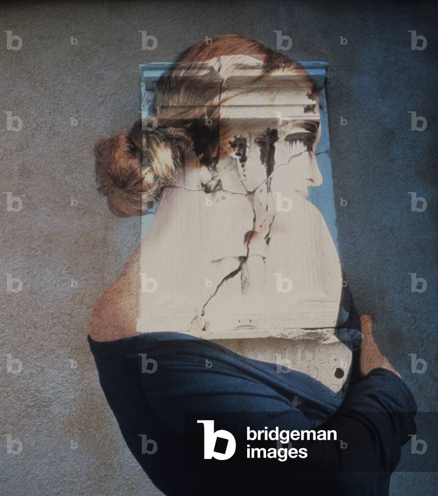 Woman covering face with self portrait