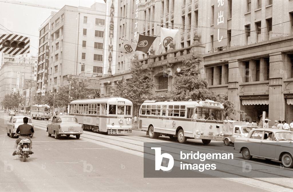 View of traffic of trams and cars on a street in Tokyo, Japan October 1961 (Trolleys and old buses in a street of Tokyo, Japan, october 1961) Anonymous photography Private collection