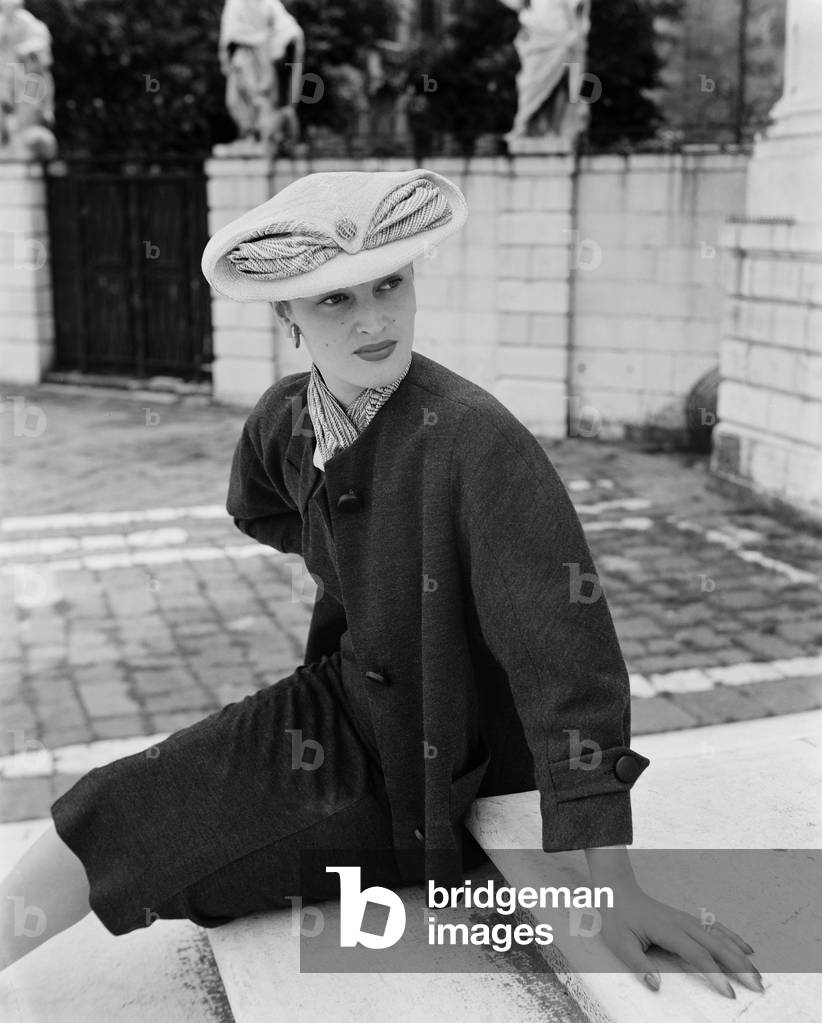 A model wearing Christian Dior fashions in Venice, 3rd June 1951 : Sitting On The Stairs