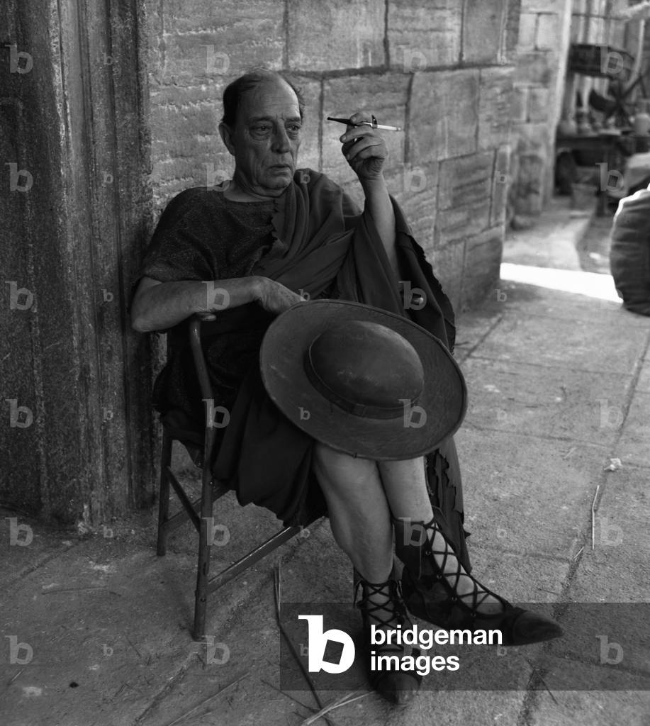 American actor Joseph 'Buster' Keaton, wearing a roman armor and smoking a sigarette, resting during the shooting of 'A Funny Thing Happened on the Way to the Forum', Rome, 1966