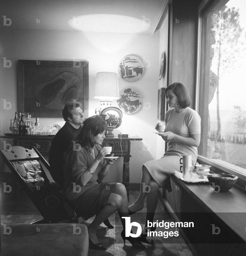 Italian actress Lucia Bose' with Franco Interlenghi and Antonella Lualdi sitting beside the window sipping a cup of tea, Madrid, 1961 : Having A Cup Of Tea