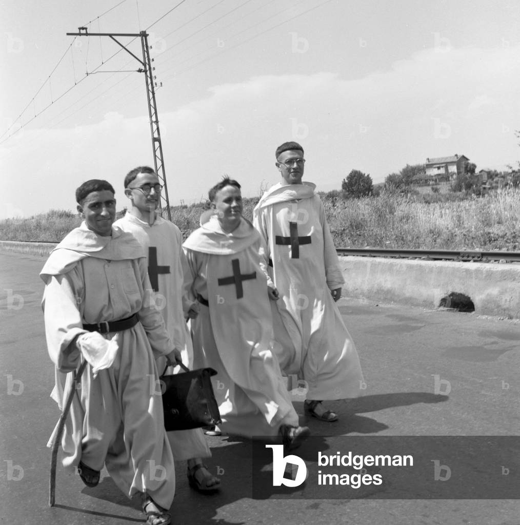Four monks walking down a country road, Italy, Rome, 1955 : A Walk
