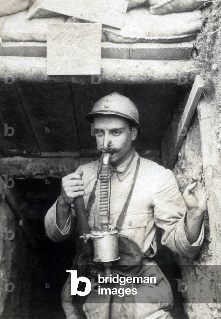 French soldier with a gas mask at the entrance of a shelter, ww1
