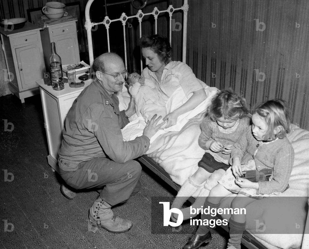 Belgium 1 January 1945.: In an American military hospital, a doctor captain of the US Army smiles at the littl