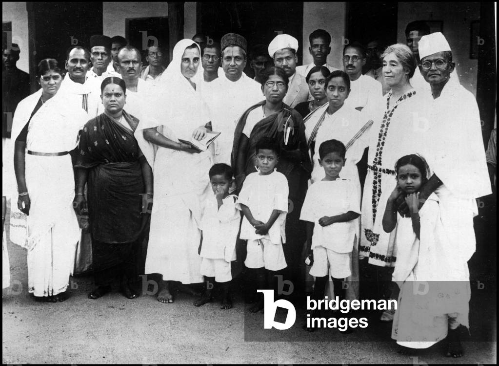 Madras (India) circa 1930: During a tour to spread Mahatma Gandhi's ideas, the daughter of American Admiral Slade (in white dress) visits Dr. Reddi Muthulakshmi (in the center with glasses)