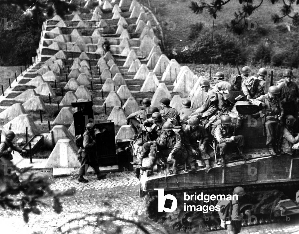 WWII:Germany September 15, 1944: Infantry soldiers of the 39th Infantry Brigade fighting with the 3rd US DB cross the “Dragon Teeth” of the Siegfried Line