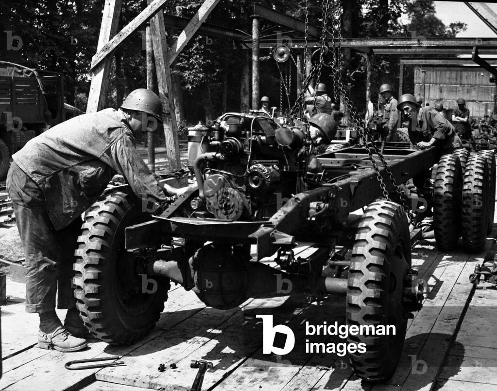 WWII:Channel (Normandy) around July 31, 1944: GMC truck assembly line in the open field