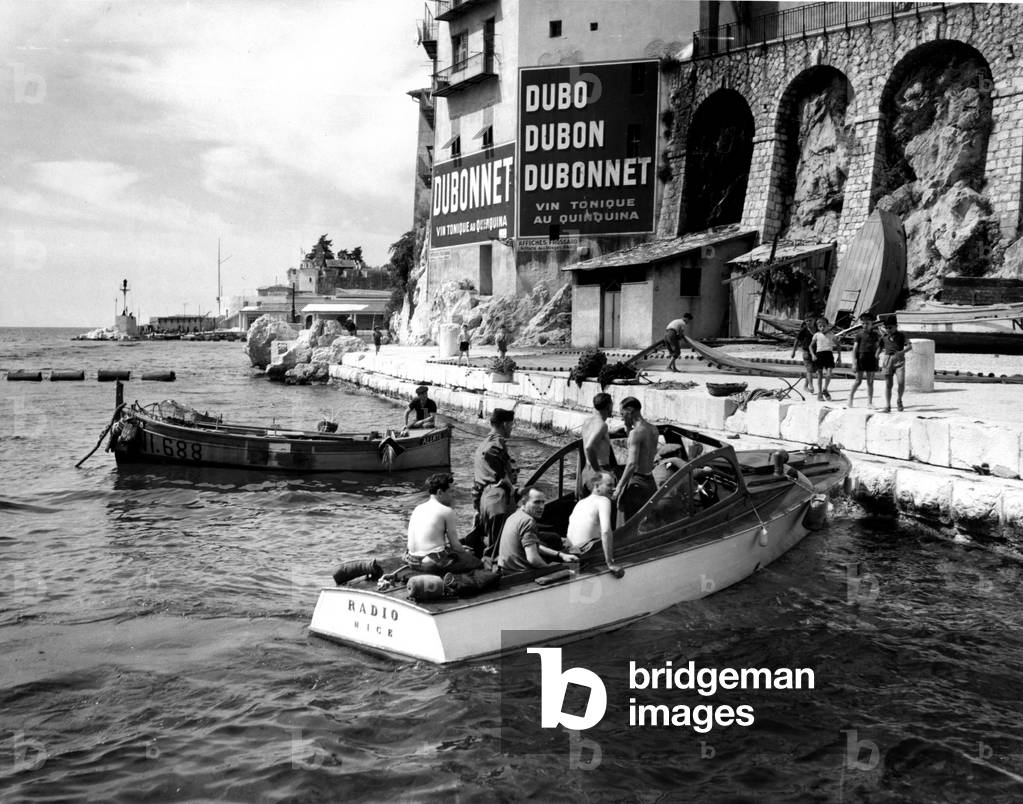 Nice (Alpes Maritimes) France 19 June 1945 These US Army soldiers stationed at Camp Calas de la Delta Base Section were granted a seven-day leave on the French Riviera before being redeployed to the Pacific - Here they return from a sea trip and on Beaurivage beach, chat with young Nicoans