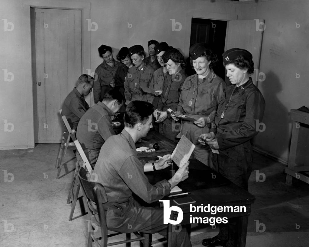 Near Mourmelon (France) 6 July 1945: At Camp Carlisle, waiting for their redeployment or repatriation, these US Army nurses record their points calculation (US Army's point system)