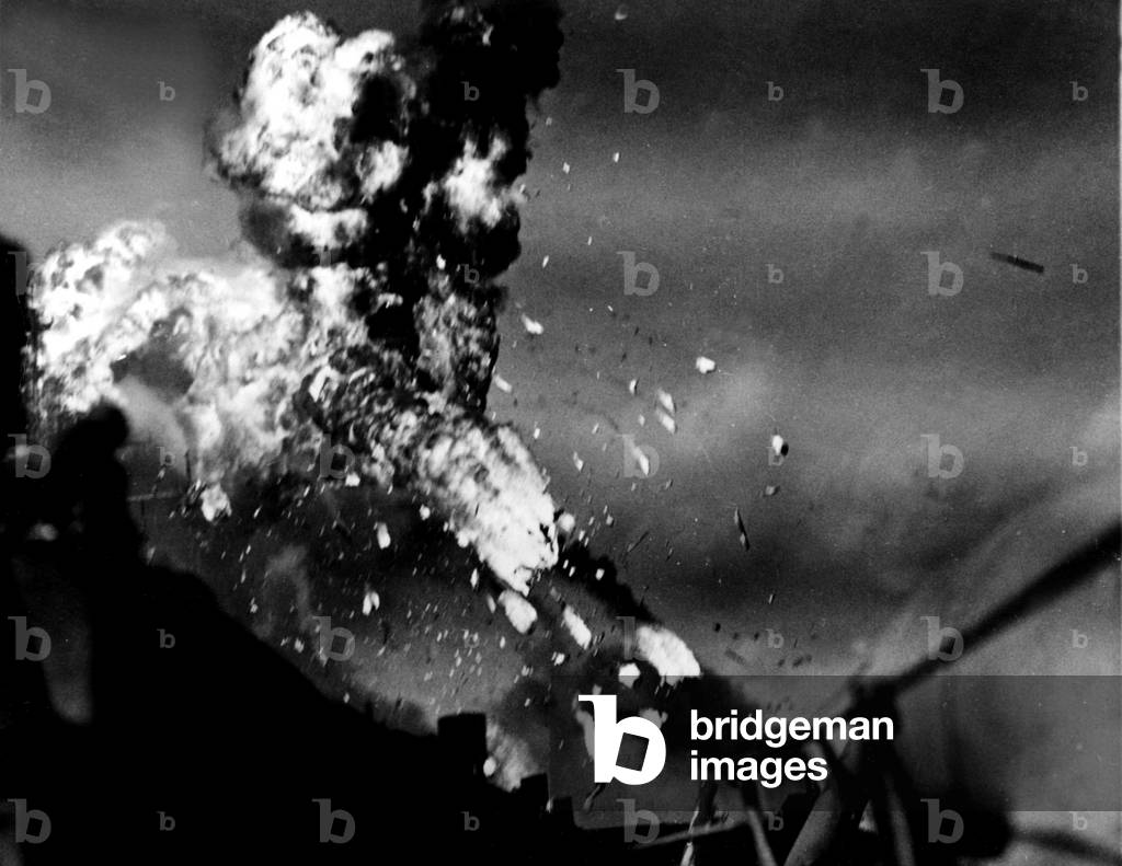 WWII:Philippines Sea (Pacific) November 25, 1944: A Japanese aircraft “” kamikaze”” disintegrates after hitting the aircraft carrier USS Intrepid (CV-11).””