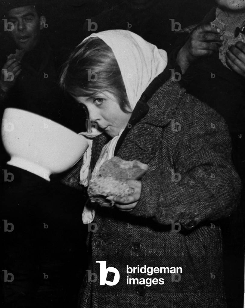 WWII:Krefeld (Germany) March 5, 1945: After the capture of the city on March 2 by elements of the 102nd D.I US, this little girl of a couple of labor deportes who have not eaten for three days can finally be satisfied