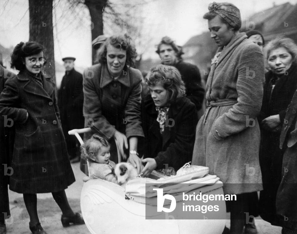 Region de la Roer (Germany) at the end of February 1945.: Evacuated from their homes when a unit of the 9th US Army took their small town, these women and children await permission from the American military authority to return home