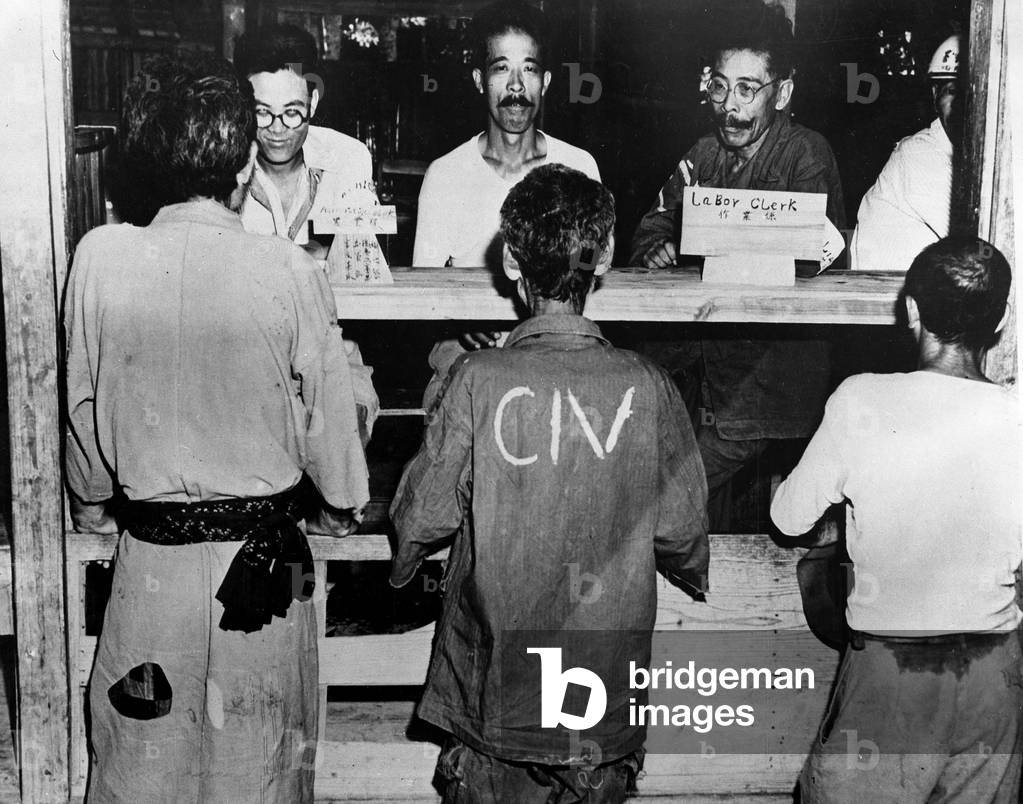 WWII:Kushi (Okinawa Island) Japan 29 June 1945: At the headquarters of the American Military Government, peasants receive information from civilian employees