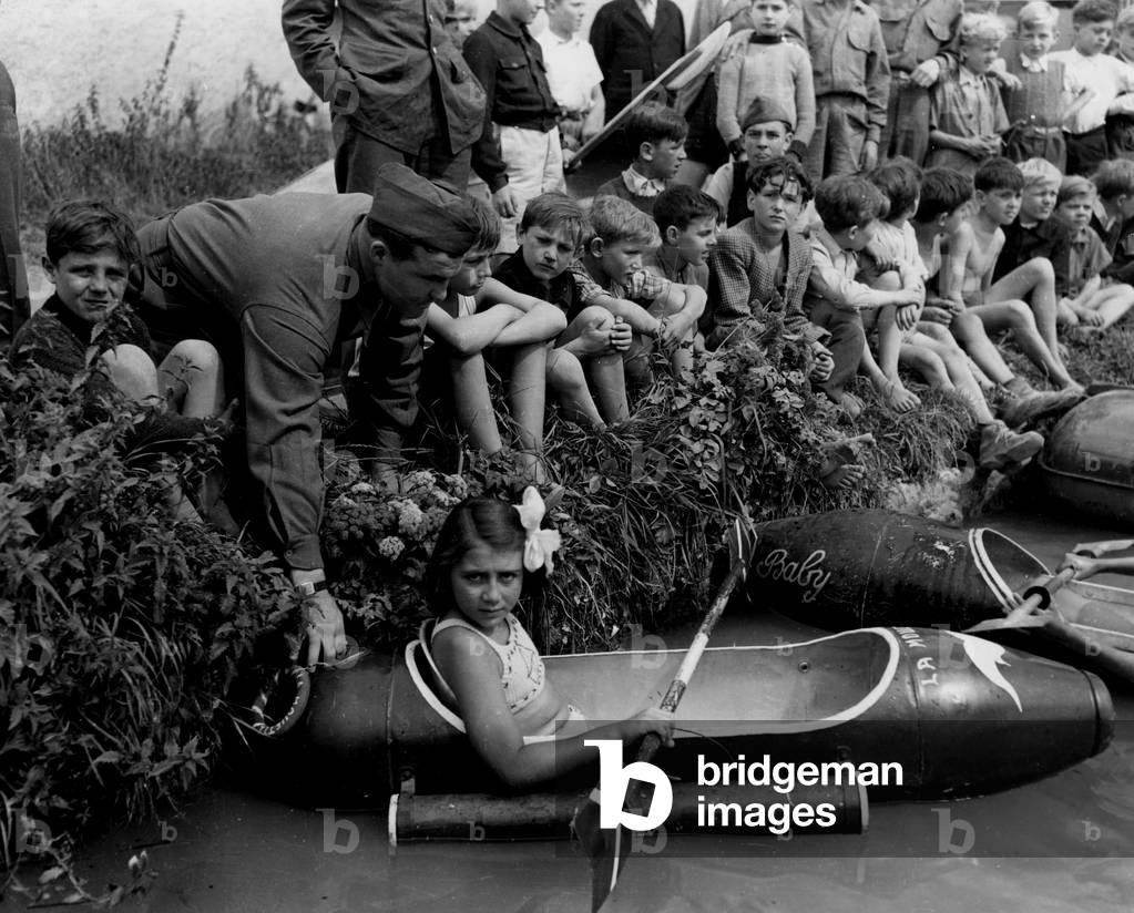 Reims (Marne) France 7 August 1945: A little girl sits in her boat “” La Mouette”” during a regatta organized by American soldiers from a redeployment camp near the city. This boat is carried out in an additional aircraft tank of the US Air Force