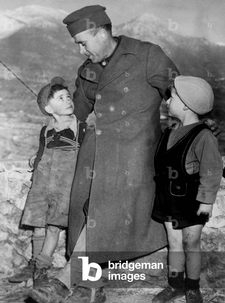Italy 12 January 1944: A soldier of the French Expeditionary Force (CEF) integrated with the V Armee Alliee sympathizes with two young boys