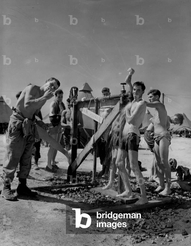 WWII:Mourmelon (Marne) France 25 July 1945: At Camp Saint Louis where American soldiers are stationed waiting to return to the United States or redeploy to the Pacific theatre of operations, these members of the 45th US DI make their morning toilet