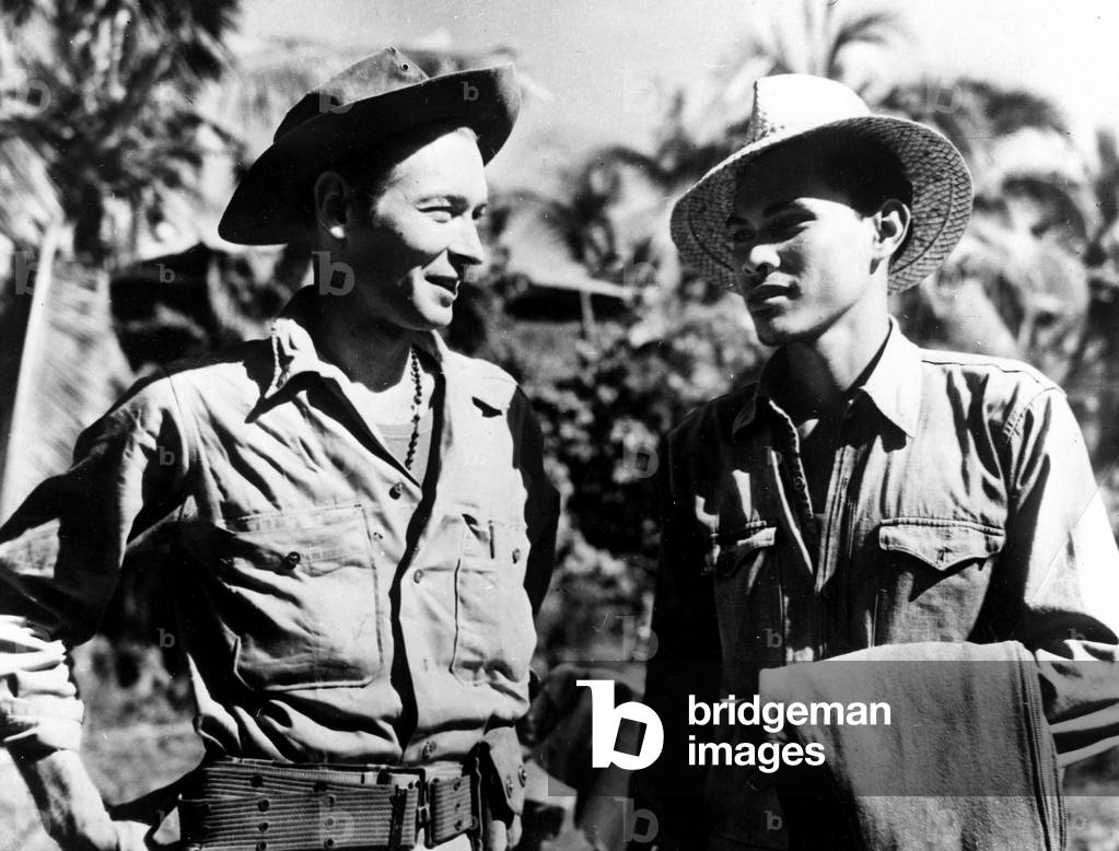 WWII:Isle of Luzon Phil 3 February 1945: Commander Robert Lapham talks with one of the guerilla couriers.