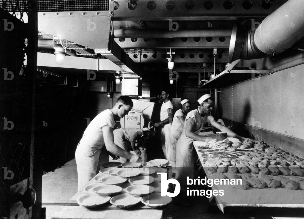 In the kitchens of the aircraft carrier several dozen pies for the ship's crew at sea, ca. 1930 - Cooks preparing pies in the kitchen aboard the aircraft carrier USS Lexington (CV-2), ca 1930