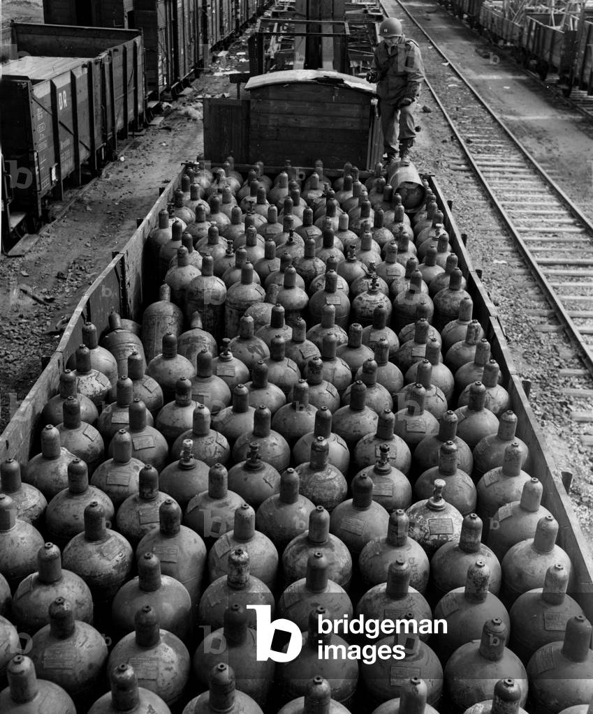 WWII:Darmstadt (Germany) 24 April 1945: A captain of the VII US Army examines a wagon of captured oxygen bombones.