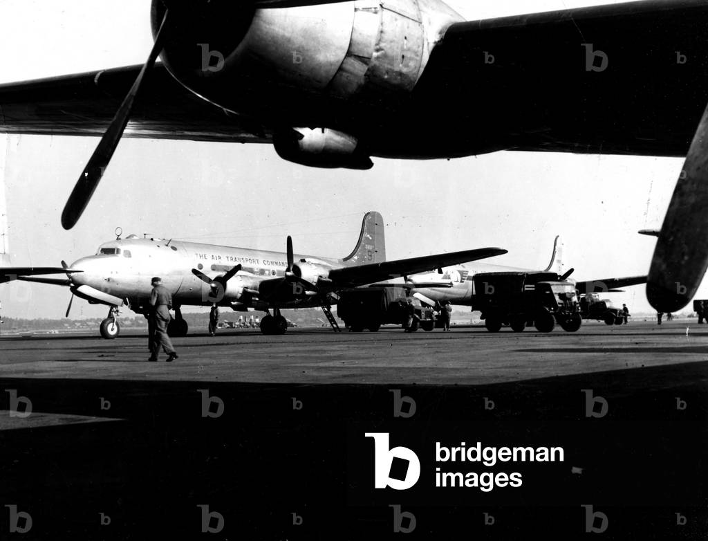 USAF C54 prepared to be discharged from their cargo, Gatow Airport, Berlin, 1948 (b/w photo)