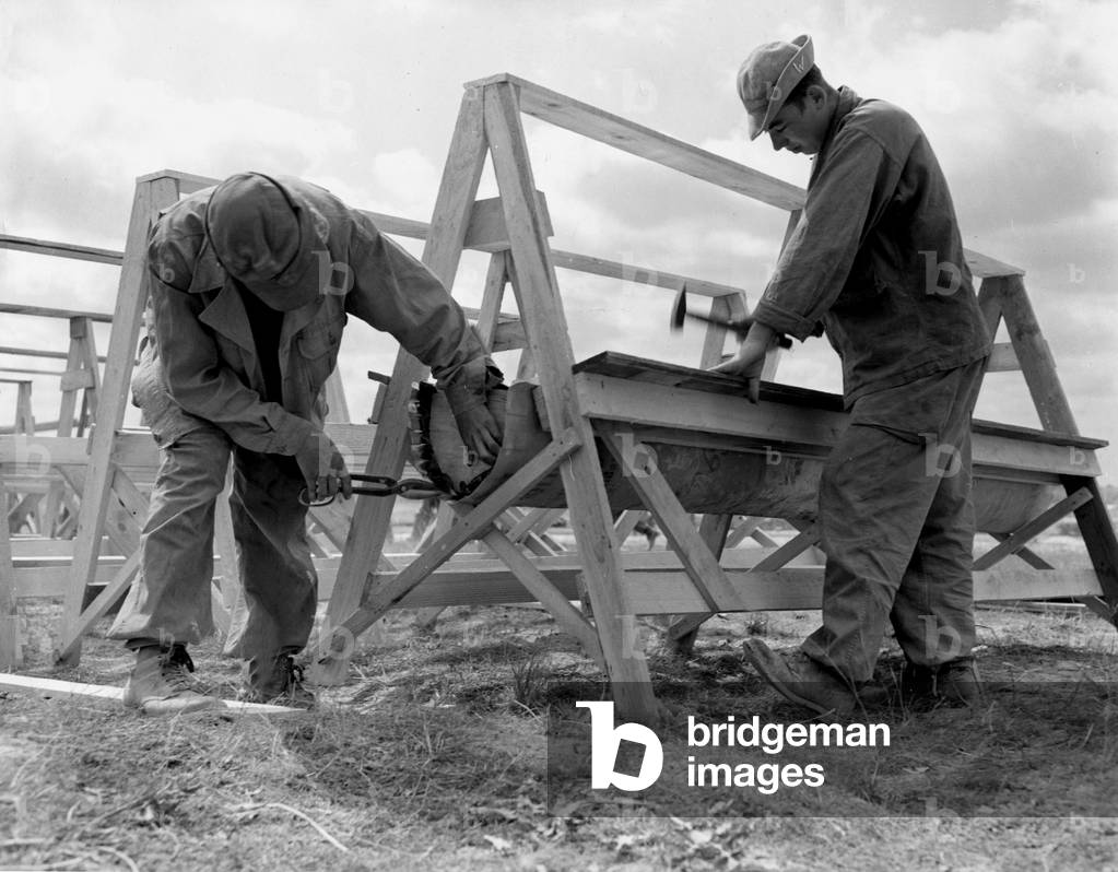 Near Mourmelon (Marne) France 25 June 1945: At the Philadelphia camp of the US Army where American soldiers awaiting redeployment to the Pacific theatre of operations are stationed, two German prisoners of war (PW) are working on the construction of shower rooms