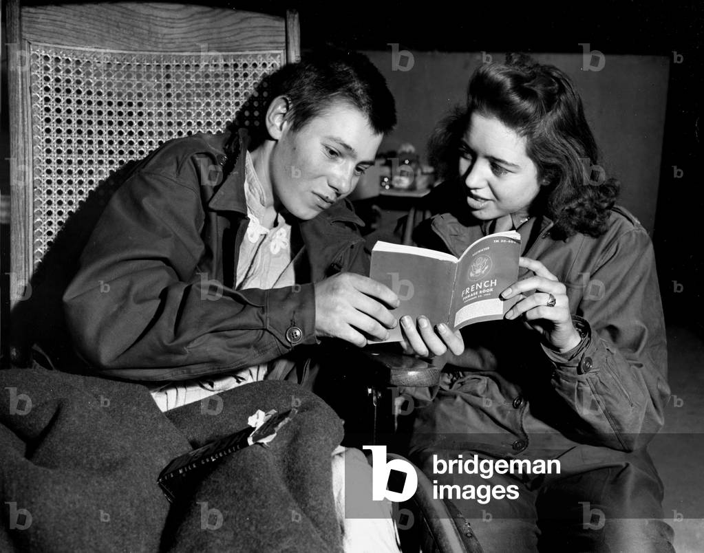 WWII:Barneville (Normandy) France March 10, 1945: At the 174th General Hospital, a young French civilian, amputed a leg, gives a lecture of French to a nurse of the US Army