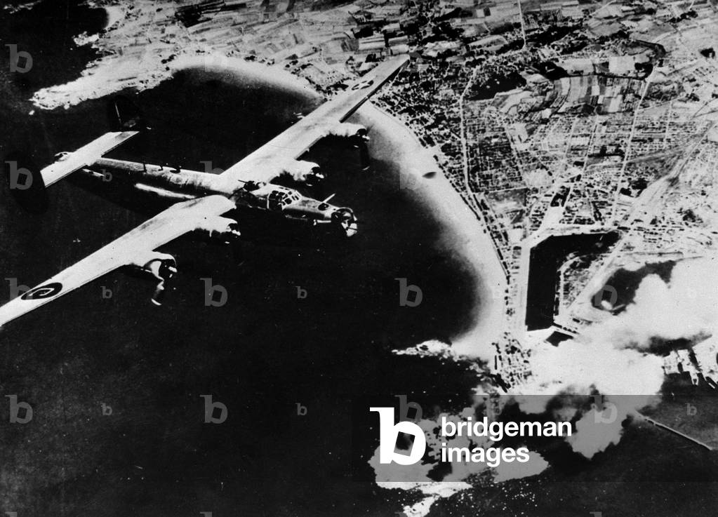 WWII:St Malo (Brittany) France 13 August 1944: A B24 Liberator of the 8th USAAF during the bombing of Cezembre Island (lower right)