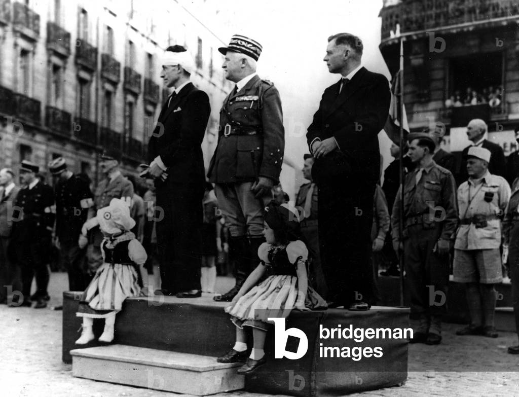 WWII:Dijon (Cote d'Or) France 13-15 September 1944: General Goislard de Monsabert (CG of the 2nd CA of the 1st French Armee) and the prefet of Dijon, Monsieur Ghuillier, attend the defile of elements of the 1st DFL during the celebration of liberation of the city on the 11th September