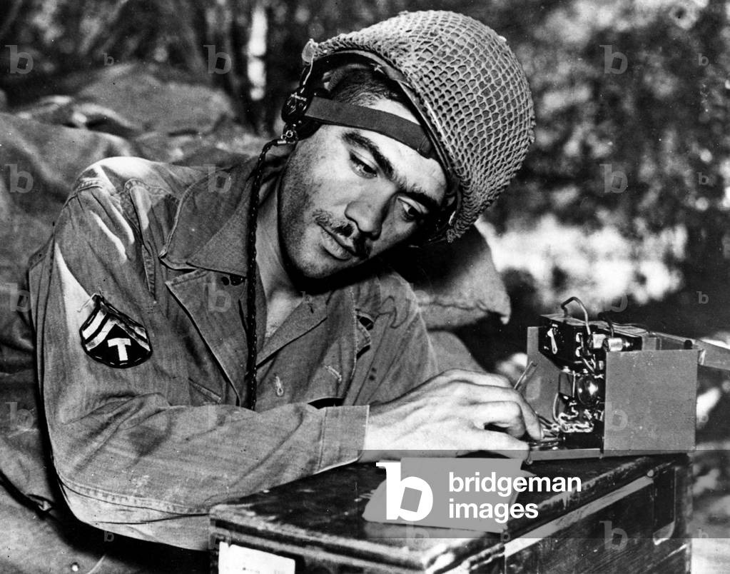WWII:Normandy (France) Summer 1944: An African American corporal of the US Army serves as a telegrapher between an artillery battery and the staff of an infantry division