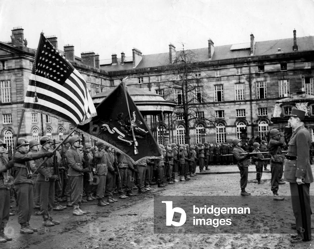 WWII:Saverne (Alsace) France 11 February 1945: During his tour in the newly liberated Alsatian cities, General De Gaulle salutes the flag of the United States, presented to him by a detachment of the 6th US Armees Group