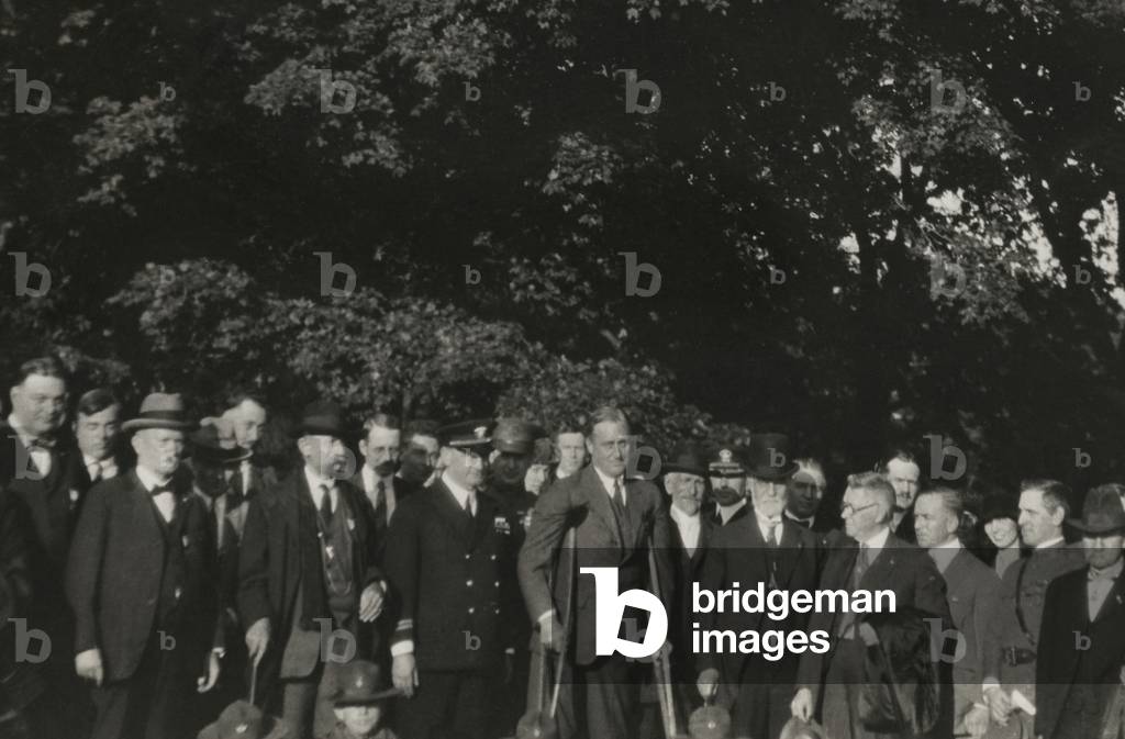 Franklin Roosevelt on crutches in a group of men at the Courthouse in Pittsburgh, 1924. In 1924 FDR used crutches, before he developed a technique combining a cane and a strong supporting companion
