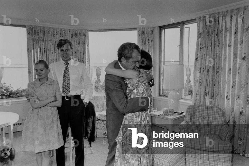 Nixon hugging his daughter Julie shortly after his decision to resign from the Presidency. In background are Edward and Tricia Nixon Cox. Aug. 8 1974