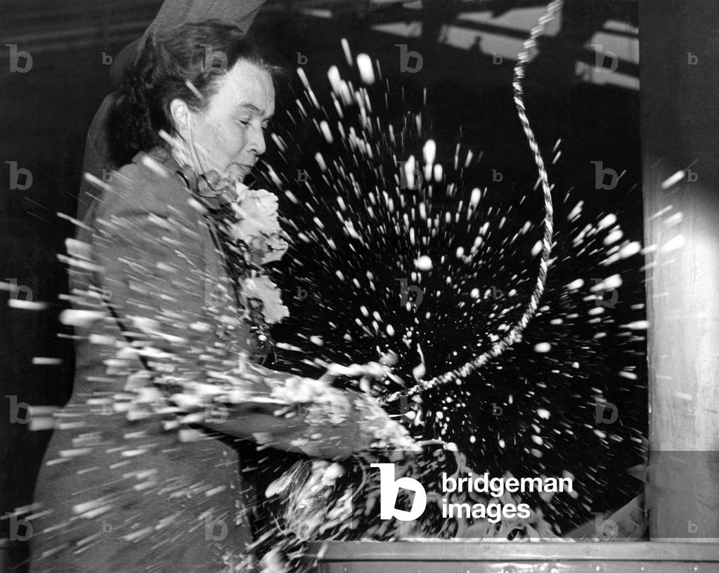 Reporter Adela Rogers St.Johns christening the combat cargo ship Achernar, a naval auxiliary, at U.S. Steel's Federal shipyard, Kearney, New Jersey, 1940s