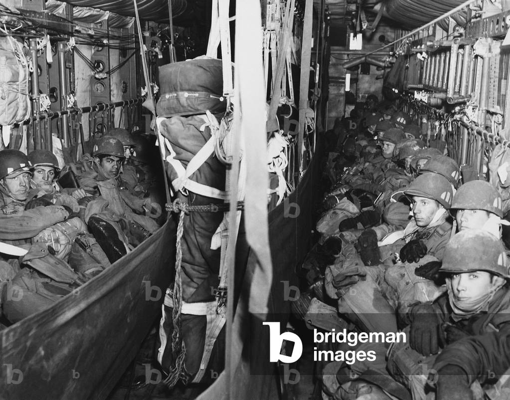 U.S. Airborne combat team en route to a drop zone at Munsan-ni, Korea, on March, 22, 1951. Packed into a C-119 Flying Boxcar, they jumped on the south bank of the Imjin River, 20 miles behind front line. Their mission to trap Communist forces retreating from Seoul was only partially successful because the enemy had already left. Korean War, 1950-53