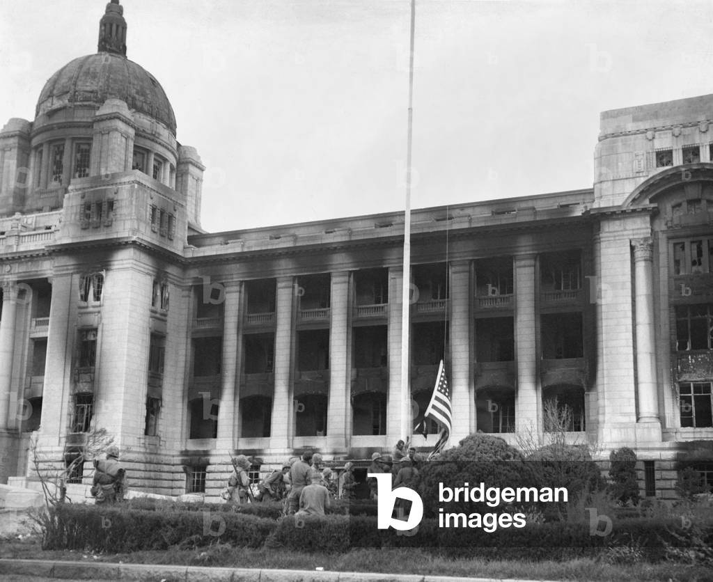 U.S. Marines raising the American flag at the burnt out South Korean Capitol building during the 2nd Battle of Seoul, Sept. 1950. Korean War, 1950-53