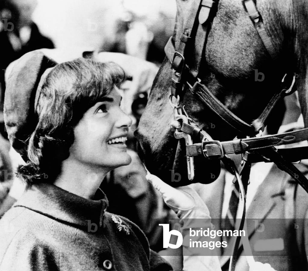 Jacqueline Kennedy beams at one of the horses of the Canadian Royal Mounted Police, Canada, 1961(b/w photo)