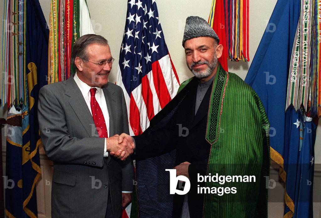 Donald H. Rumsfeld U.S. Sec. of Defense greets Hamid Karzai right chairman of the Afghan Interim Administration to replace the recently defeated Taliban government brought down by CENTCOM forces. Washington D.C. Jan. 28 2002., Photo by:Everett Collection