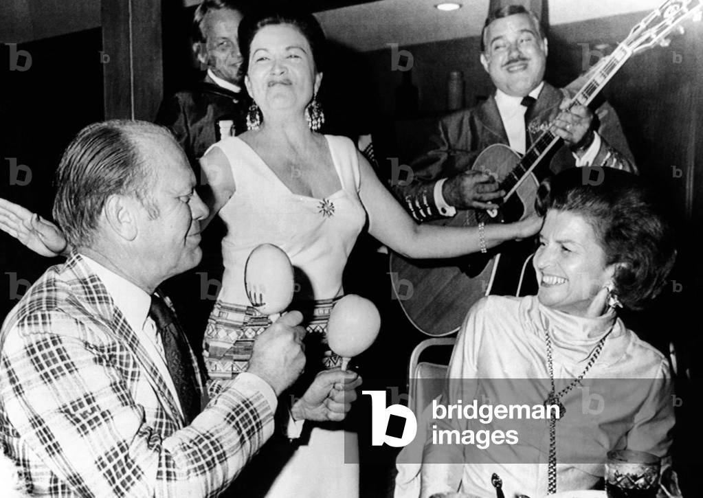 Vice President Gerald dancing with Maracas Rumba shakers. Betty Ford enjoys her serenade in Palm Springs, California. April 19, 1974