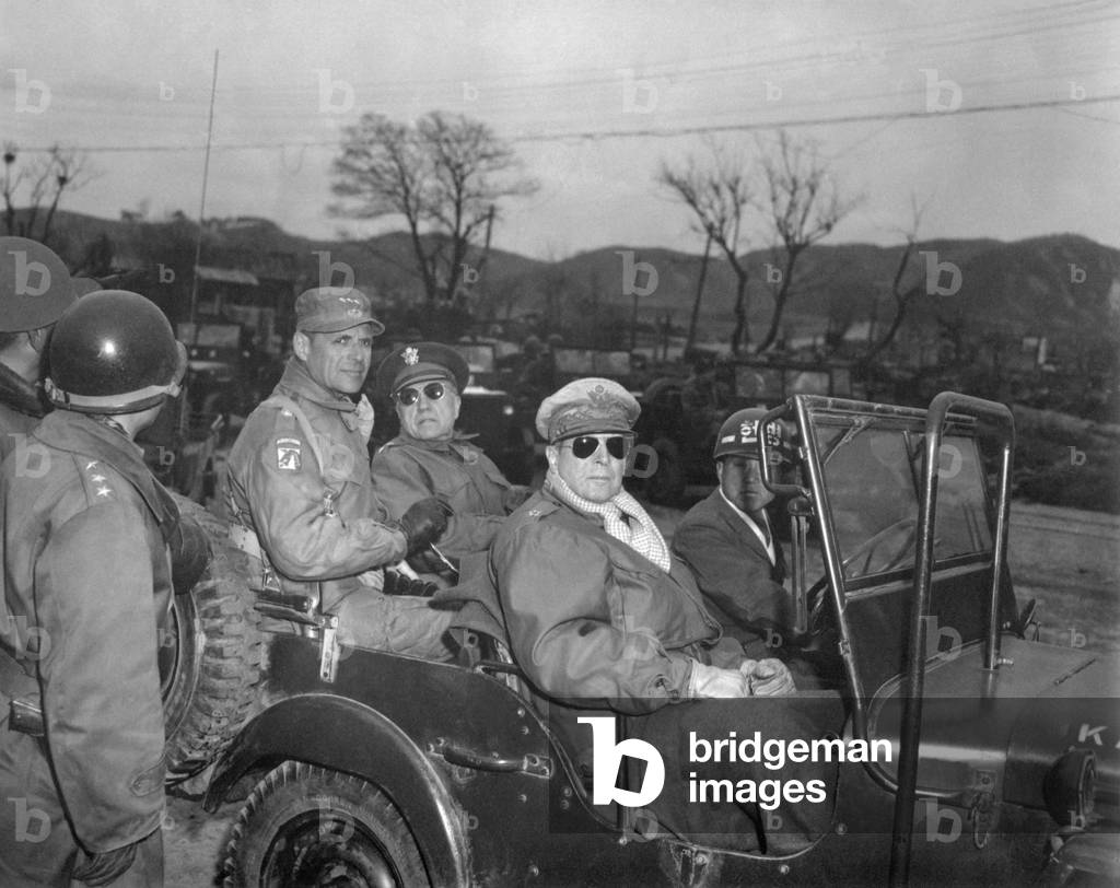 Commanders of U.N. Forces in Korea, in a jeep at a command post, Yang Yang, approximately 15 miles north of the 38th parallel, April 3, 1951. A week later Gen. Douglas MacArthur (right, sunglasses), was relieved of his command and replaced by Lt. Gen. Matthew Ridgeway (hat with 3 stars). Beside Ridgeway is Maj. Gen. Doyle Hickey. Korean War, 1950-53
