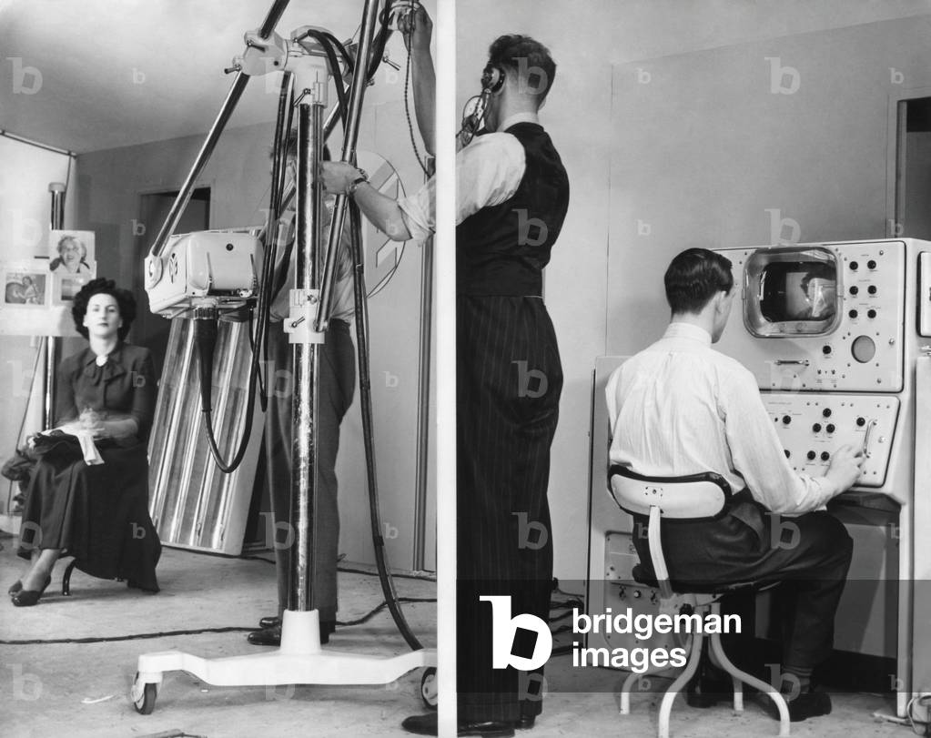 Color television is demonstrated at Radiolympia Exhibition in London. Sept 1949. The method demonstrated employs synchronized rotating color filters in both the camera and receiver (on right), giving 50 pictures per second in the three primary colors, which the human eye blends into full color.