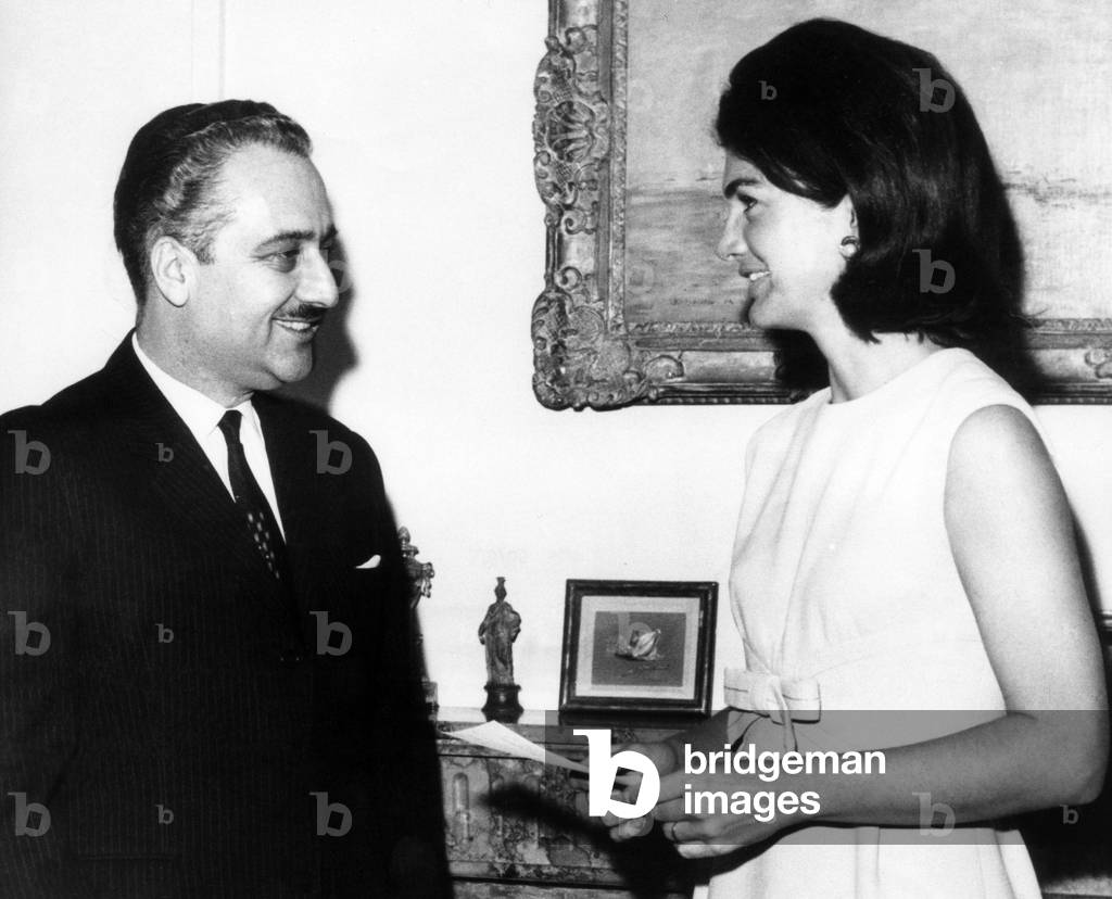 Ambassador Talat Al-Ghoussein of Kuwait and Jacqueline Kennedy, after he presented her with a fifty thousand dollar check for the John F. Kennedy Memorial Library, New York, March 6, 1965.